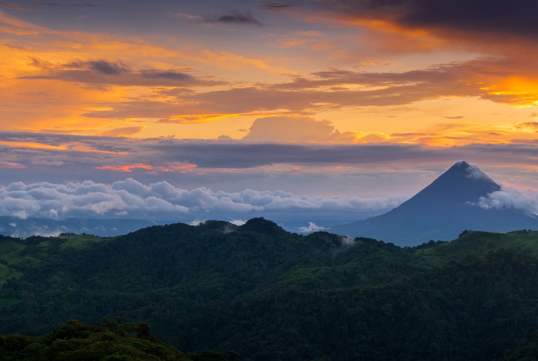 Sunset over forested hills and a distant volcano near Monteverde, Costa Rica