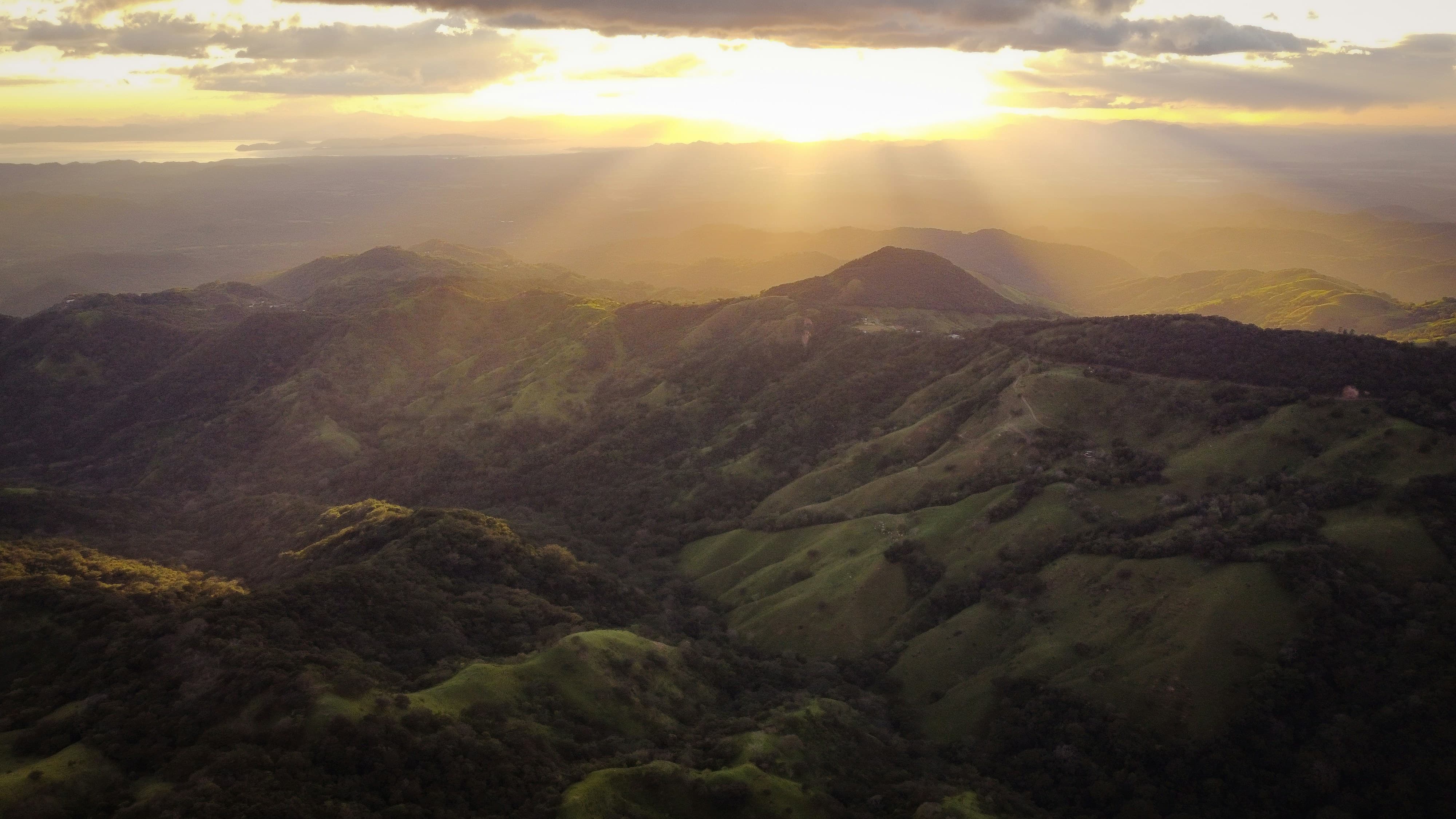 Golden sunlight and mist over Monteverde’s rolling green hills in Costa Rica