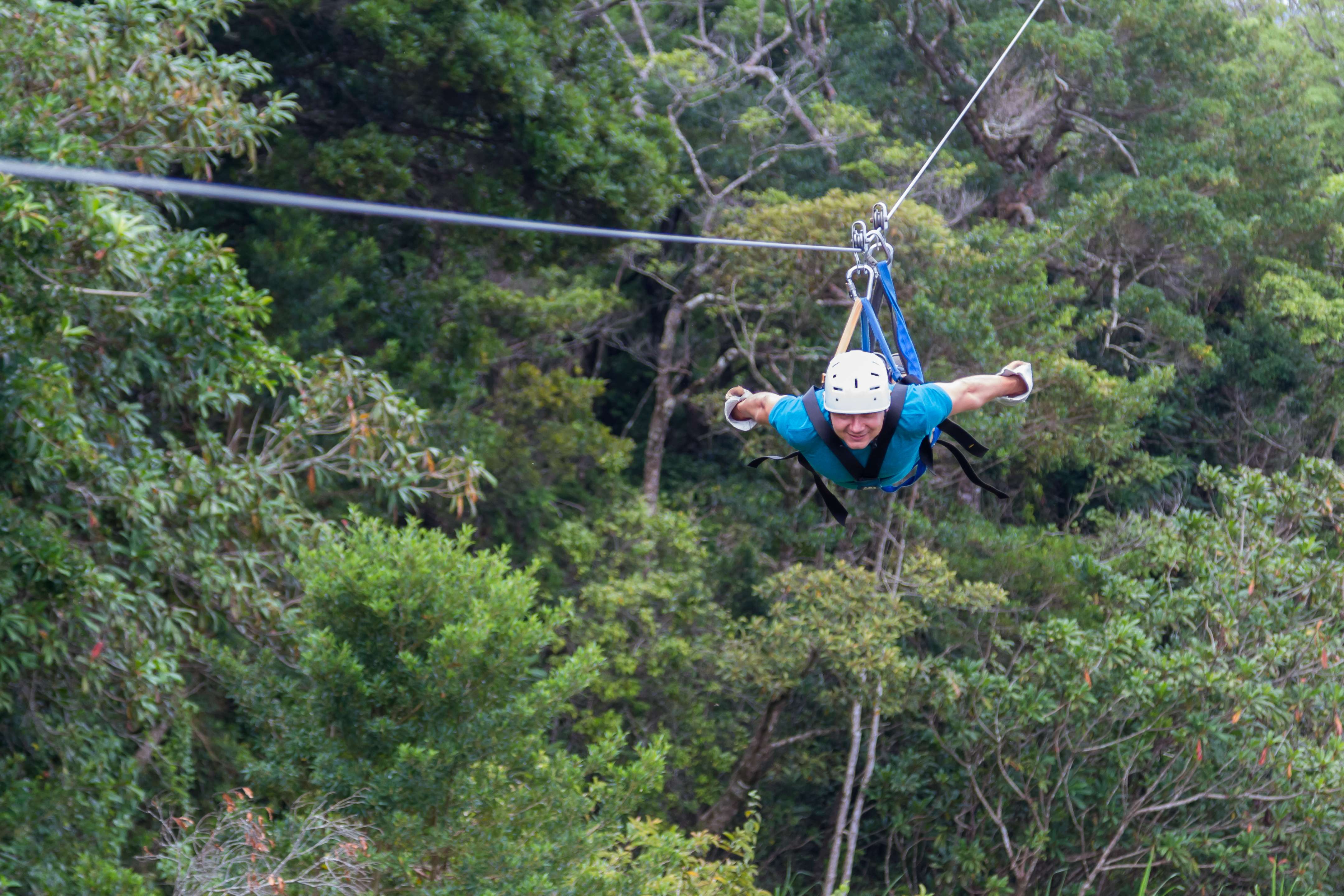 Person enjoying the Superman zipline at Extremo Monteverde, Costa Rica.